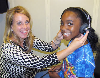 Girl getting hearing evaluation for new hearing aids